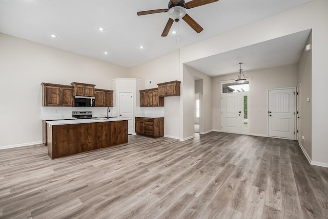 20444 W 125th Ter, Olathe, KS 66061 - kitchen with appliances with stainless steel finishes, light wood-style floors, ceiling fan, a center island with sink, and light countertops