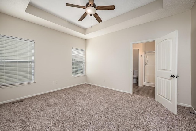 20444 W 125th Ter, Olathe, KS 66061 - unfurnished bedroom with carpet floors, a tray ceiling, and a ceiling fan
