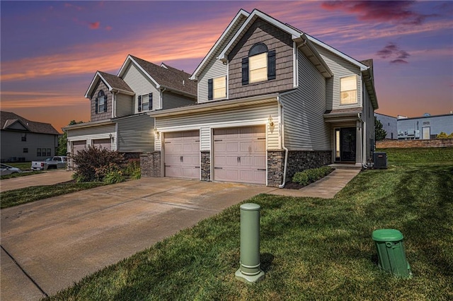 9583 N Main St, Kansas City, MO 64155 - traditional-style home featuring an attached garage, driveway, stone siding, and a yard
