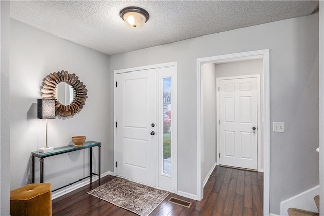 9583 N Main St, Kansas City, MO 64155 - foyer featuring dark wood-style floors and a textured ceiling