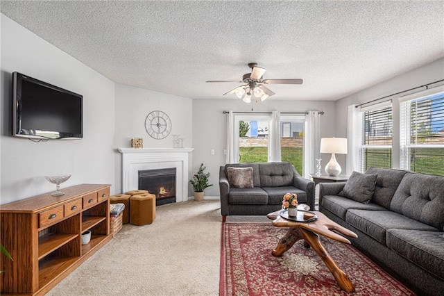 9583 N Main St, Kansas City, MO 64155 - carpeted living area featuring a glass covered fireplace, a ceiling fan, and a textured ceiling