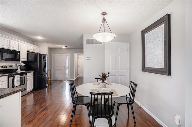 9583 N Main St, Kansas City, MO 64155 - dining room with dark wood finished floors and a textured ceiling