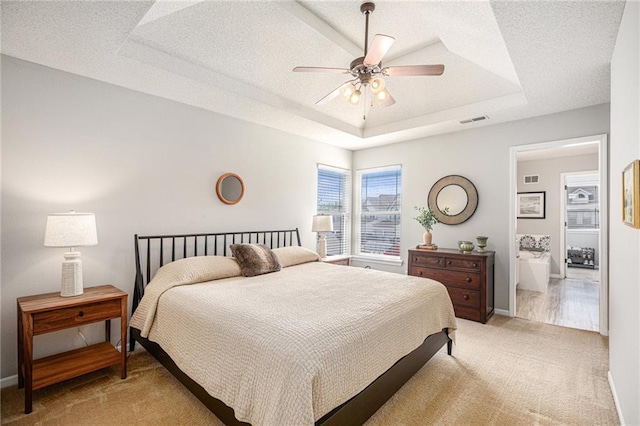 9583 N Main St, Kansas City, MO 64155 - bedroom with light colored carpet, a tray ceiling, and a ceiling fan
