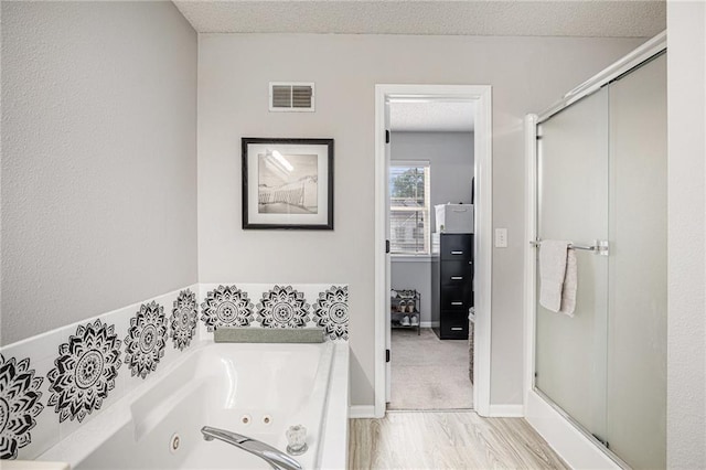 9583 N Main St, Kansas City, MO 64155 - full bathroom featuring a shower stall, a tub with jets, and a textured ceiling