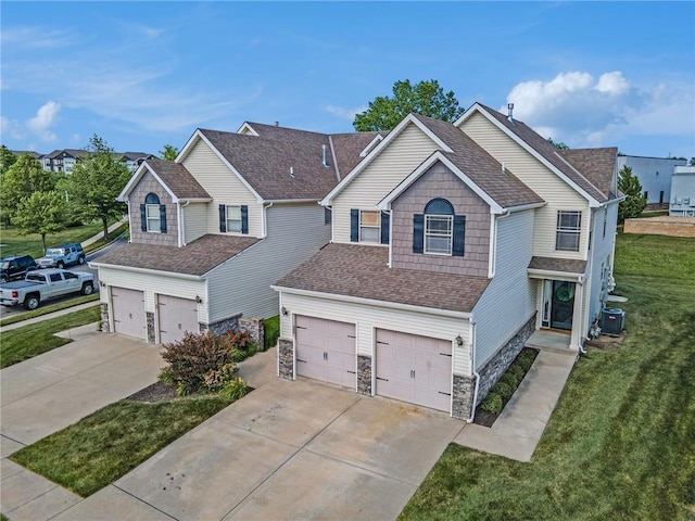 9583 N Main St, Kansas City, MO 64155 - traditional-style home featuring driveway, a garage, stone siding, a front yard, and roof with shingles