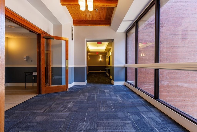 308 W 8th St Unit 409, Kansas City, MO 64105 - hallway featuring carpet floors, wood ceiling, and brick wall