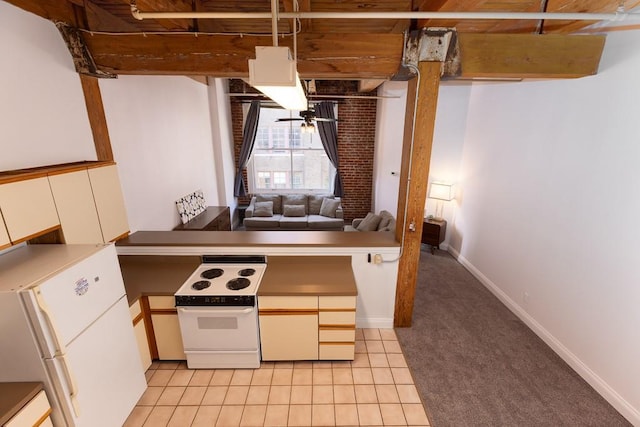 308 W 8th St Unit 409, Kansas City, MO 64105 - kitchen featuring white appliances, light carpet, light tile patterned floors, white cabinetry, and a peninsula
