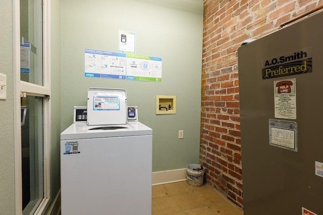 308 W 8th St Unit 409, Kansas City, MO 64105 - washroom with washer / dryer, tile patterned floors, and brick wall