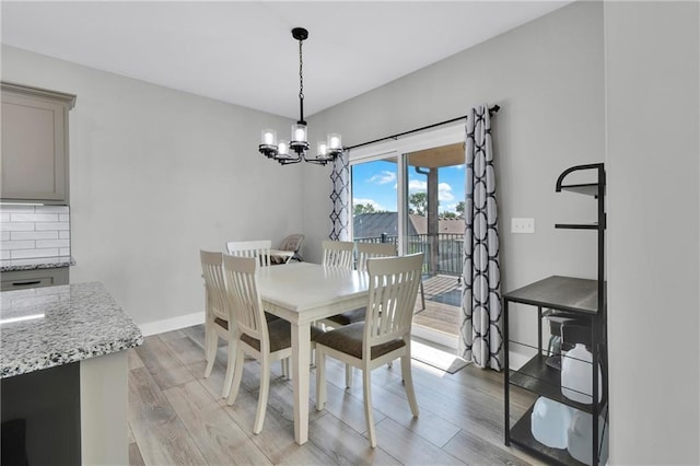 307 S Wilson St, Archie, MO 64725 - dining area featuring a chandelier and light wood-style flooring