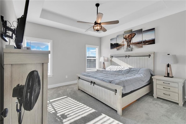 307 S Wilson St, Archie, MO 64725 - bedroom featuring carpet floors, a tray ceiling, and a ceiling fan