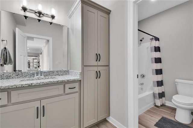 307 S Wilson St, Archie, MO 64725 - full bath featuring wood finished floors, vanity, and shower / tub combo with curtain