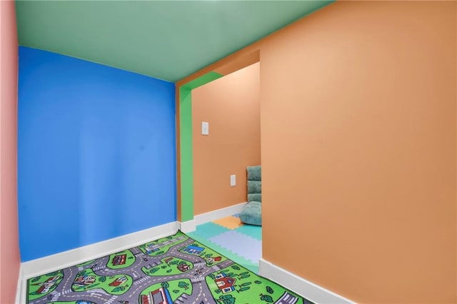 307 S Wilson St, Archie, MO 64725 - rec room featuring baseboards and carpet