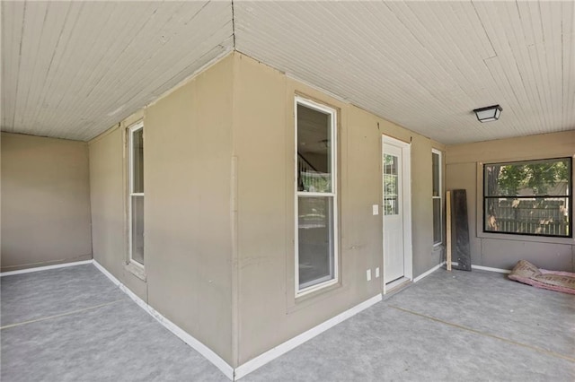 526 S Maple St, Ottawa, KS 66067 - unfurnished sunroom with wooden ceiling and carpet floors