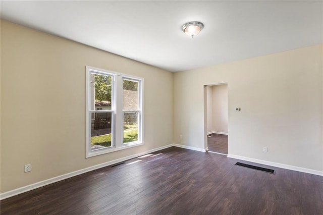 526 S Maple St, Ottawa, KS 66067 - spare room with dark wood-style floors and baseboards