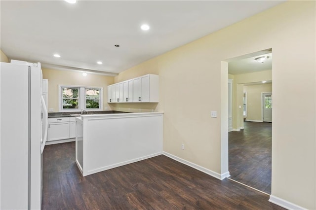 526 S Maple St, Ottawa, KS 66067 - kitchen featuring freestanding refrigerator, dark wood finished floors, white cabinets, recessed lighting, and a peninsula