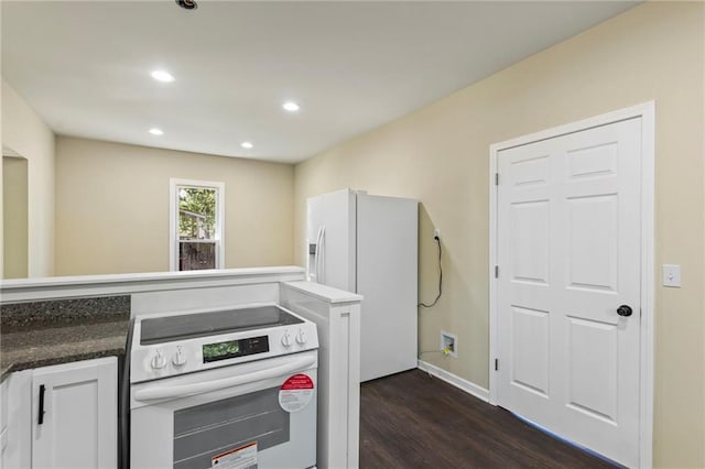 526 S Maple St, Ottawa, KS 66067 - kitchen with white appliances, dark wood-type flooring, recessed lighting, white cabinets, and dark countertops