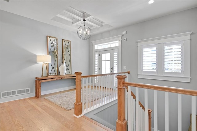2210 W 73rd St, Prairie Village, KS 66208 - hallway with coffered ceiling, wood finished floors, a chandelier, beamed ceiling, and recessed lighting