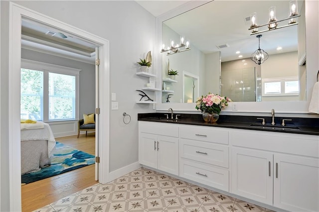 2210 W 73rd St, Prairie Village, KS 66208 - full bathroom with a chandelier, double vanity, a shower stall, ensuite bath, and wood finished floors
