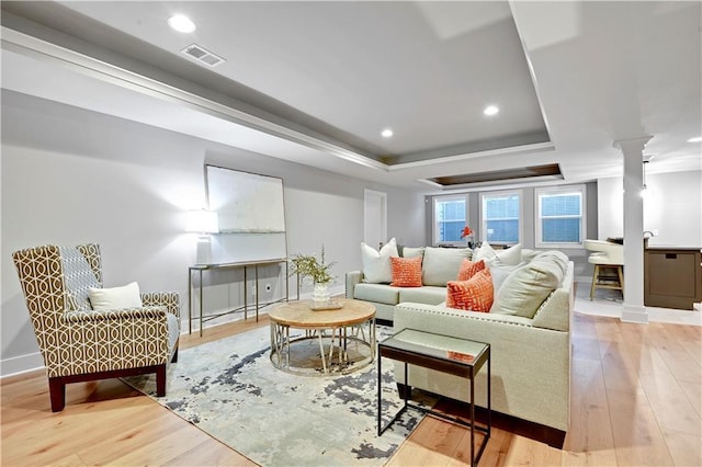 2210 W 73rd St, Prairie Village, KS 66208 - living room featuring ornate columns, a raised ceiling, wood finished floors, and recessed lighting