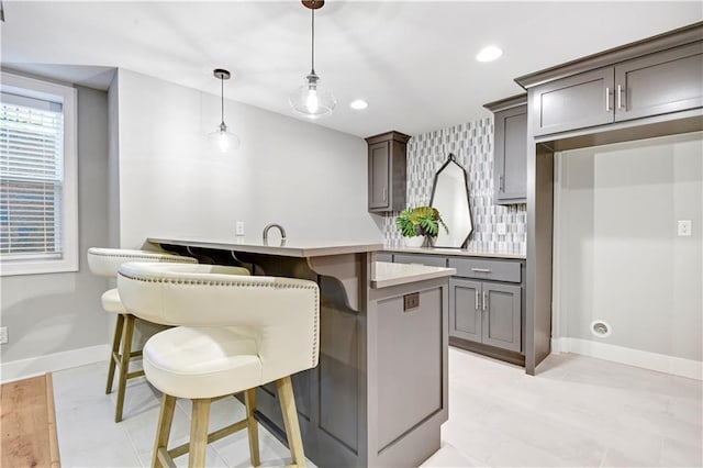 2210 W 73rd St, Prairie Village, KS 66208 - kitchen featuring a kitchen bar, hanging light fixtures, backsplash, light countertops, and recessed lighting