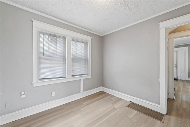 3544 College Ave, Kansas City, MO 64128 - empty room with wood finished floors, a textured ceiling, and ornamental molding