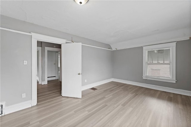 3544 College Ave, Kansas City, MO 64128 - unfurnished room with wood finished floors and baseboards