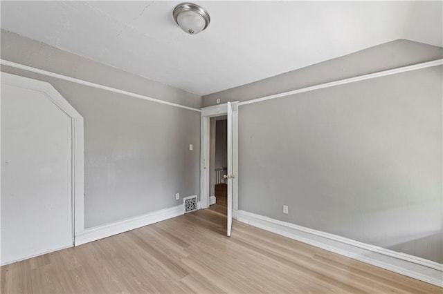 3544 College Ave, Kansas City, MO 64128 - unfurnished room with wood finished floors and baseboards
