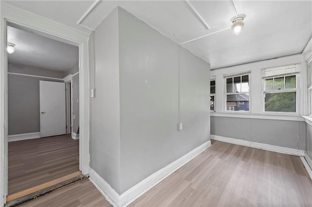 3544 College Ave, Kansas City, MO 64128 - spare room with wood finished floors and baseboards