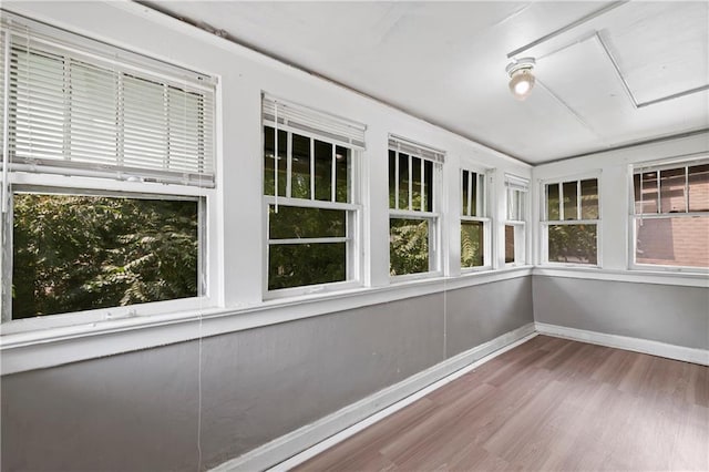3544 College Ave, Kansas City, MO 64128 - unfurnished sunroom with wood finished floors and plenty of natural light