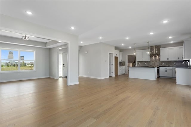 16772 S Twilight Ln, Olathe, KS 66062 - unfurnished living room with light wood-style flooring and recessed lighting