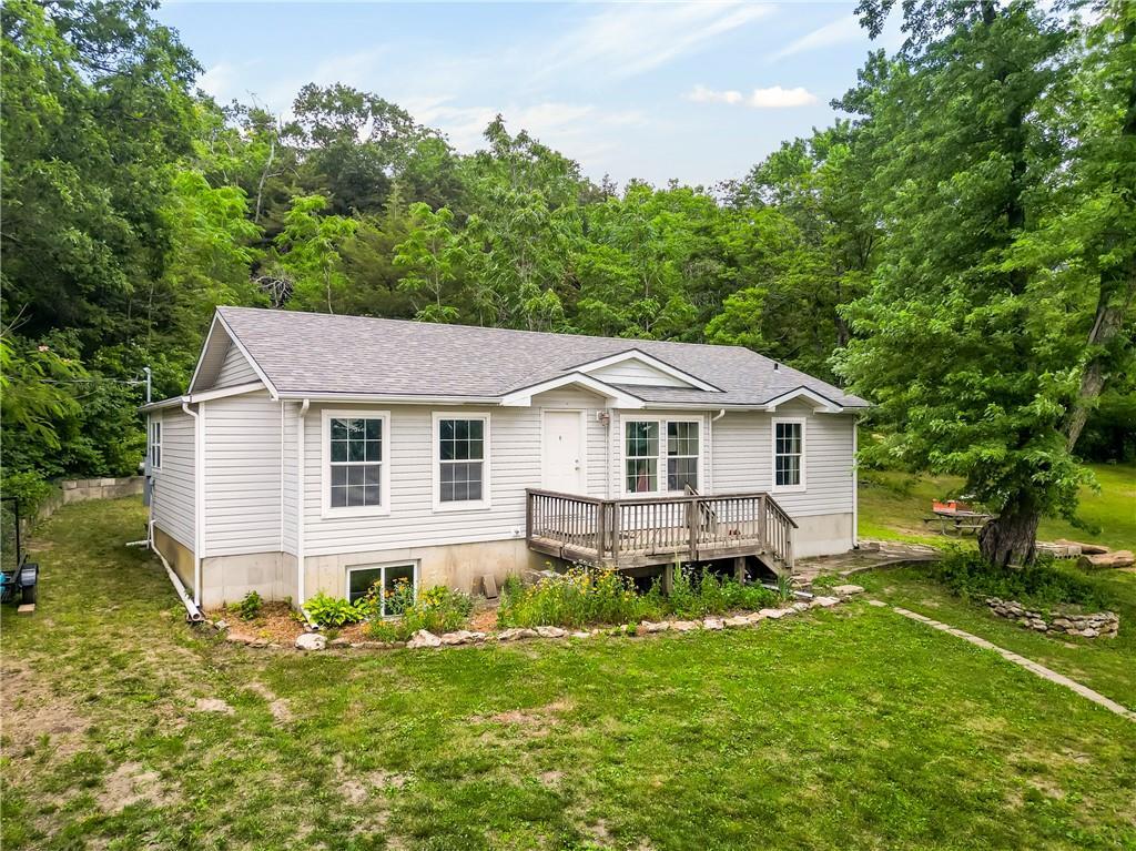 1540 N 600th Rd, Baldwin City, KS 66006 - view of front of home with a deck, a front lawn, and roof with shingles