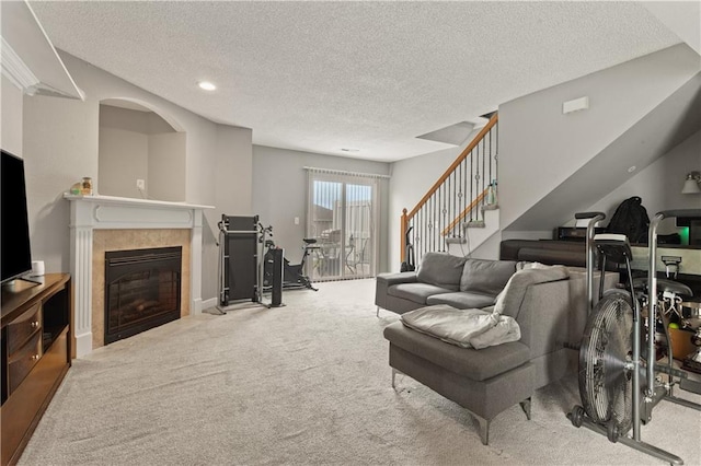 820 Peach Tree Ln, Blue Springs, MO 64064 - living area with carpet floors, stairway, a textured ceiling, a tile fireplace, and recessed lighting