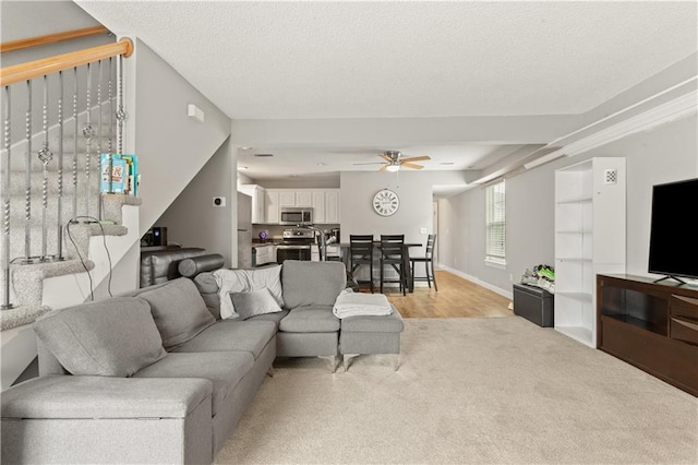 820 Peach Tree Ln, Blue Springs, MO 64064 - living area with a ceiling fan, light colored carpet, and a textured ceiling