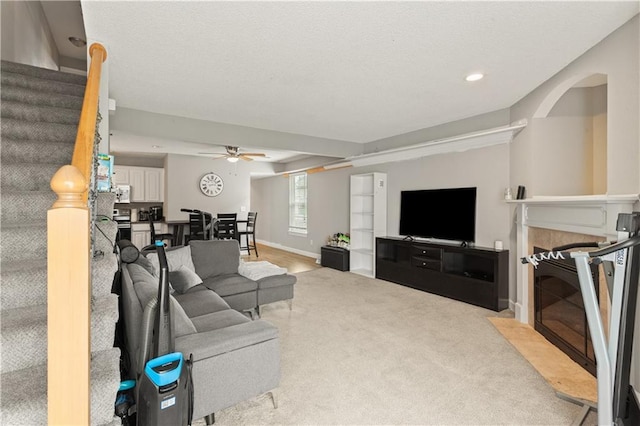 820 Peach Tree Ln, Blue Springs, MO 64064 - carpeted living area with ceiling fan, stairs, a high end fireplace, and recessed lighting