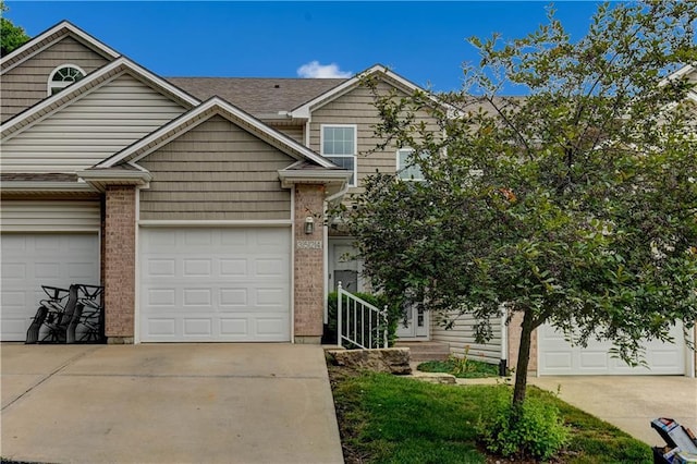 3524 NE Austin Dr, Lees Summit, MO 64064 - view of front of property with driveway, brick siding, and a garage