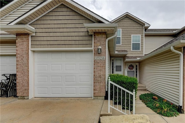 3524 NE Austin Dr, Lees Summit, MO 64064 - townhome / multi-family property with a garage, concrete driveway, and brick siding