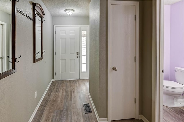 3524 NE Austin Dr, Lees Summit, MO 64064 - foyer with wood finished floors and a textured ceiling