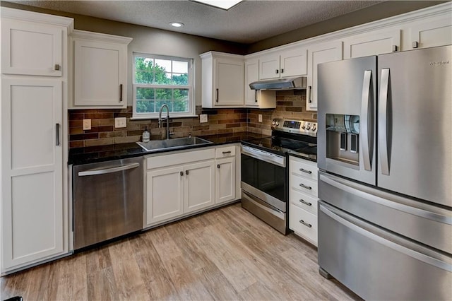 3524 NE Austin Dr, Lees Summit, MO 64064 - kitchen with appliances with stainless steel finishes, under cabinet range hood, dark countertops, white cabinetry, and recessed lighting