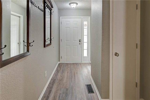3524 NE Austin Dr, Lees Summit, MO 64064 - foyer entrance with a textured ceiling, wood finished floors, and a textured wall