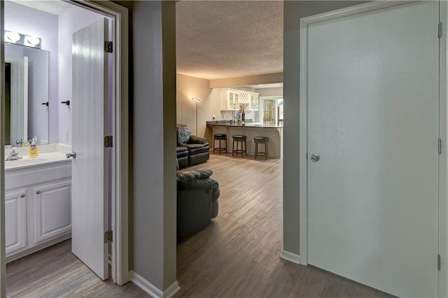3524 NE Austin Dr, Lees Summit, MO 64064 - hallway featuring a textured ceiling and wood finished floors