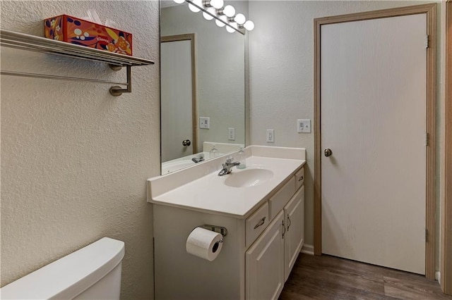 3524 NE Austin Dr, Lees Summit, MO 64064 - bathroom with wood finished floors, vanity, and a textured wall