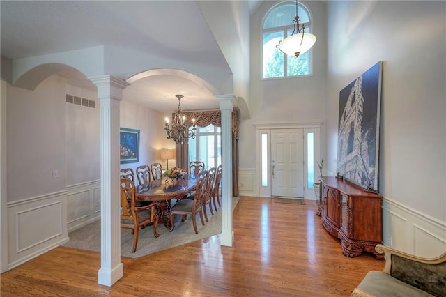 3013 S Granite Ave, Blue Springs, MO 64015 - entryway with decorative columns, arched walkways, a chandelier, a decorative wall, and a wainscoted wall