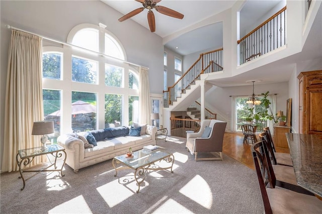 3013 S Granite Ave, Blue Springs, MO 64015 - carpeted living area featuring a high ceiling, a ceiling fan, and stairway