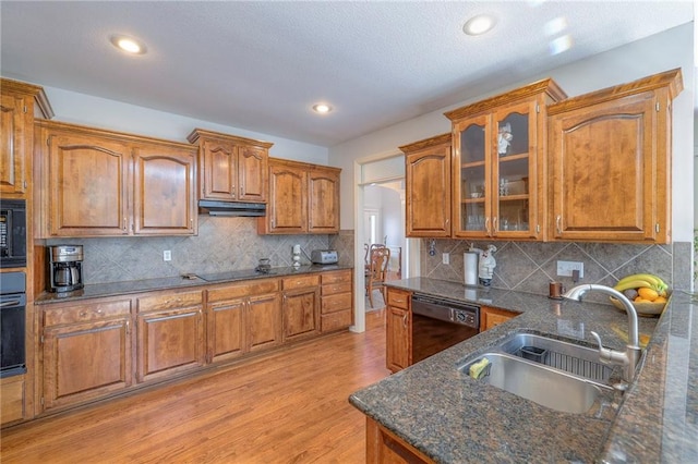 3013 S Granite Ave, Blue Springs, MO 64015 - kitchen featuring black appliances, brown cabinets, light wood-style floors, glass insert cabinets, and dark stone counters