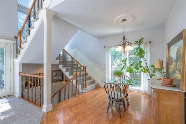 3013 S Granite Ave, Blue Springs, MO 64015 - dining room with a chandelier, plenty of natural light, stairway, and wood finished floors