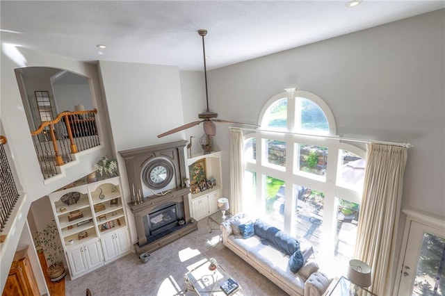 3013 S Granite Ave, Blue Springs, MO 64015 - living room with light carpet, a high ceiling, built in features, recessed lighting, and ceiling fan