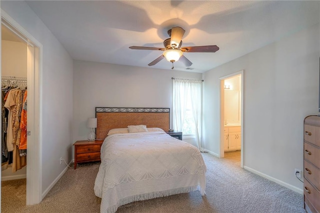 3013 S Granite Ave, Blue Springs, MO 64015 - bedroom with a spacious closet, light colored carpet, a ceiling fan, and ensuite bathroom