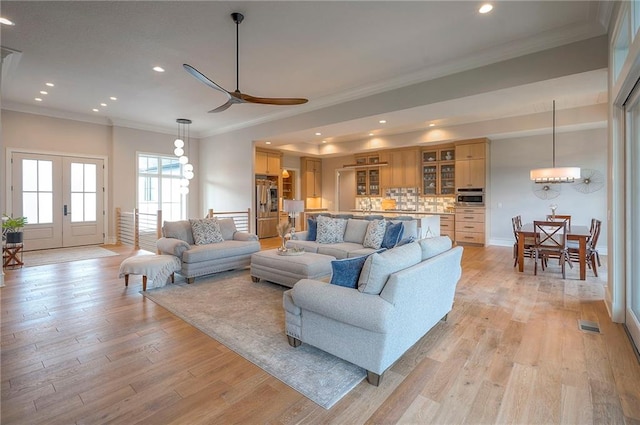 7736 N Donnelly Ave, Kansas City, MO 64158 - living room featuring crown molding, a ceiling fan, recessed lighting, light wood finished floors, and french doors