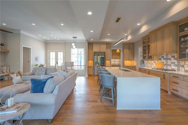 7736 N Donnelly Ave, Kansas City, MO 64158 - living area featuring light wood-type flooring, crown molding, recessed lighting, and french doors