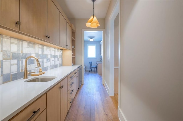 7736 N Donnelly Ave, Kansas City, MO 64158 - kitchen featuring light wood-style flooring, light countertops, decorative backsplash, open shelves, and light brown cabinetry